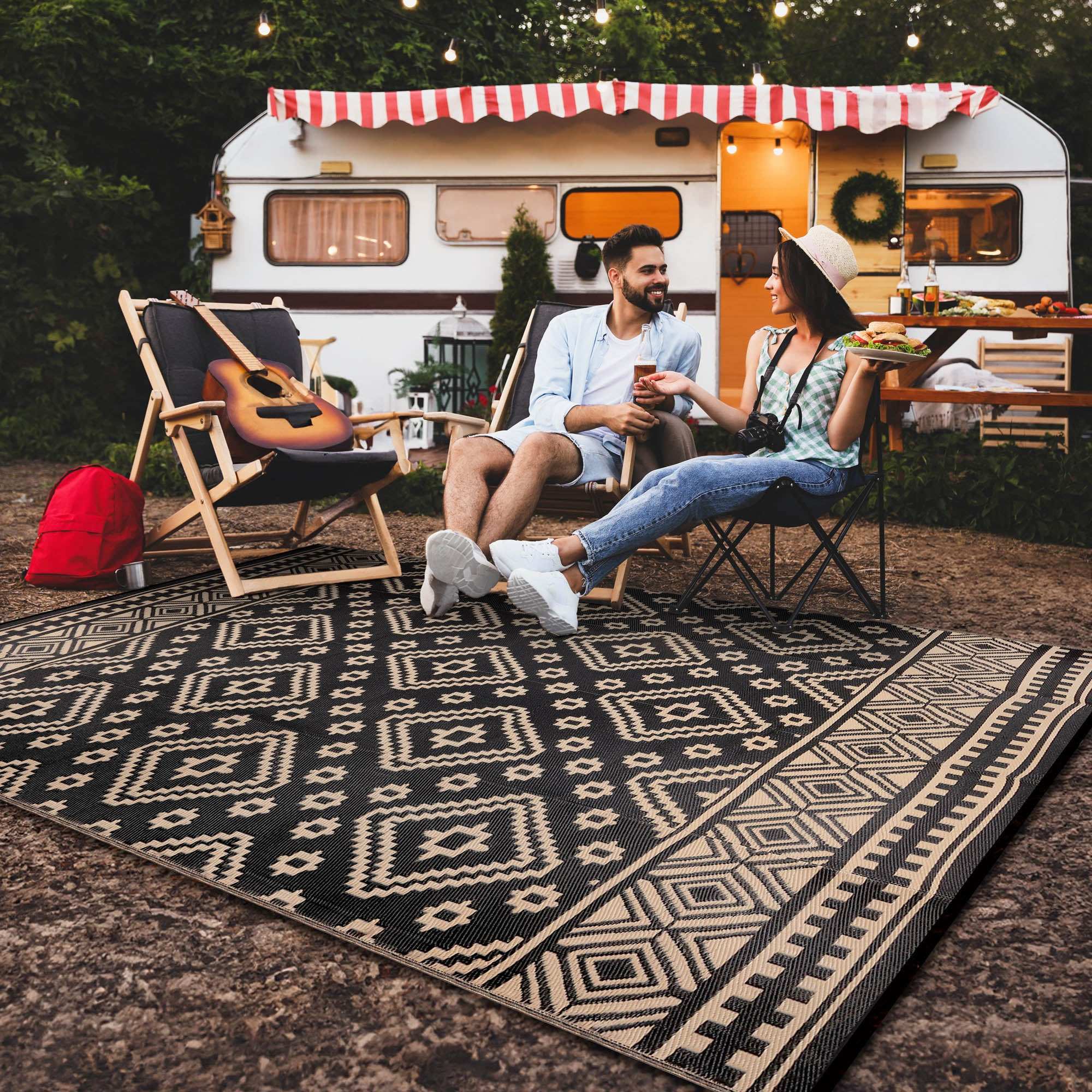 Camping rugs made of recycled plastic materials arranged at a campsite with tent and outdoor furniture