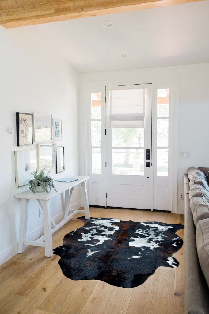 Cowhide rug decor ideas in White Scandinavian Entryway