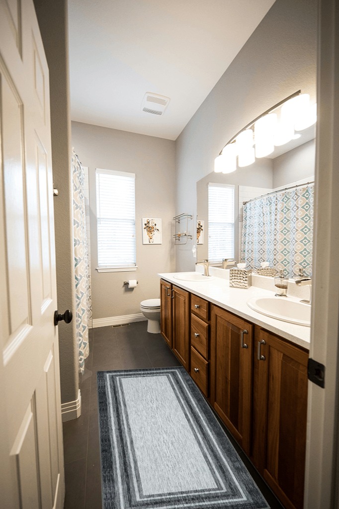 Are black rugs a bad idea in Wooden and Grey Bathroom