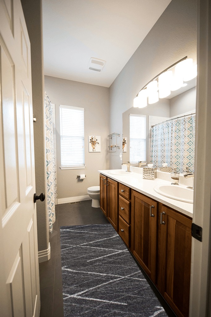 Are black rugs a bad idea in Wooden and Grey Bathroom