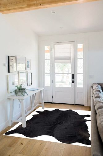 Gaucho Cowhides Solid Black Cowhide Rug - Natural Product in White Scandinavian Entryway