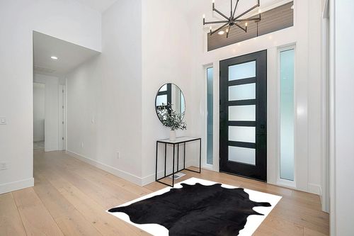 Gaucho Cowhides Solid Black Cowhide Rug - Natural Product in Modern White Entryway