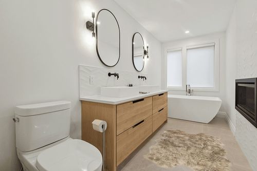 Nouvelle Legende® Faux Fur Sheepskin Premium Rug Quattro (43 in. X 73 in.) Tan in Scandinavian Neutral bathroom