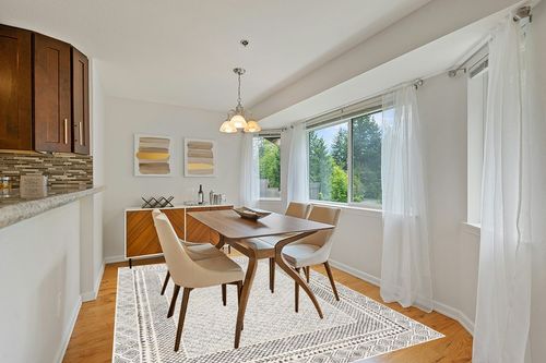 Artistic Weavers Melodie Boho Farmhouse Area Rug,6'7" x 9',Beige in Modern White Dining Room with Wooden Accents
