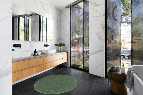 4 Ft Round Green fluffy rug in Modern Black Tiled bathroom