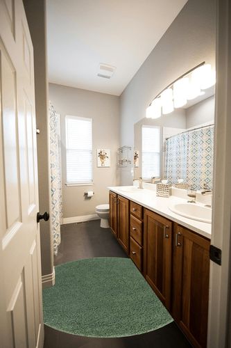 4 Ft Round Green fluffy rug in Wooden and Grey Bathroom