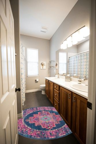 HomeRoots 4' Blue Round Power Loom Area Rug in Wooden and Grey Bathroom