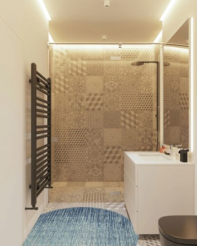 HomeRoots 4' Ivory and Blue Round Abstract Power Loom Area Rug in White Tiled Bathroom