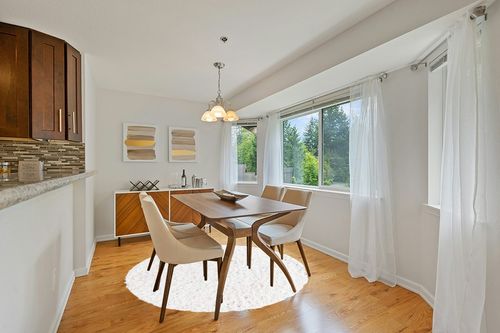 White 6 Ft Round  Shag Rug in Modern White Dining Room with Wooden Accents