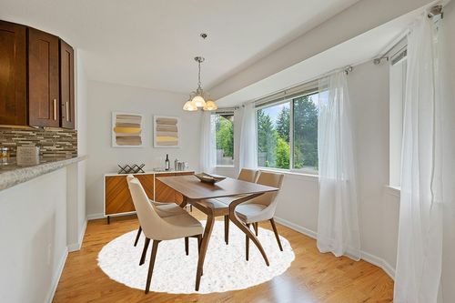 White 7 Ft Round  Shag Rug in Modern White Dining Room with Wooden Accents