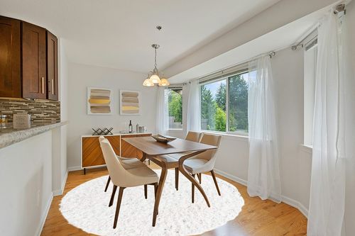 White 8 Ft Round  Shag Rug in Modern White Dining Room with Wooden Accents
