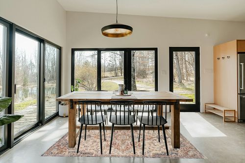 Loloi II Sorrento Collection SOR-05 Ivory/Fiesta 5'-3" x 7'-6" Area Rug in Scandinavian Dining Room with Rectangular Table