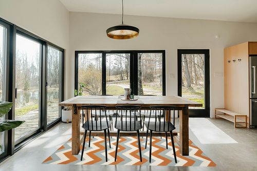 Safavieh 5' x 8' Dhurries Dhu640c Terracotta / Blue Rug in Scandinavian Dining Room with Rectangular Table
