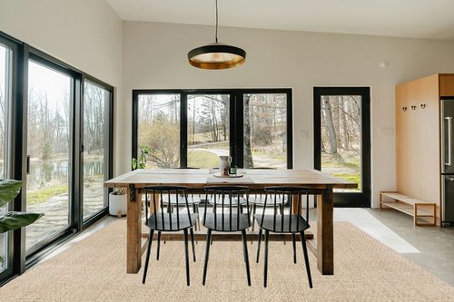 SAFAVIEH Natural Fiber Collection Area Rug - 9' x 12', Natural & Beige, Border Basketweave Seagrass Design, Easy Care, Ideal for High Traffic Areas in Living Room, Bedroom (NF114A) in Scandinavian Dining Room with Rectangular Table