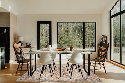 Loloi II Sorrento Collection SOR-05 Ivory/Fiesta 5'-3" x 7'-6" Area Rug in Modern Scandinavian Dining Room with Black Accents