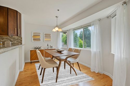 nuLOOM Kira Machine Washable Tribal Geometric Area Rug in Modern White Dining Room with Wooden Accents