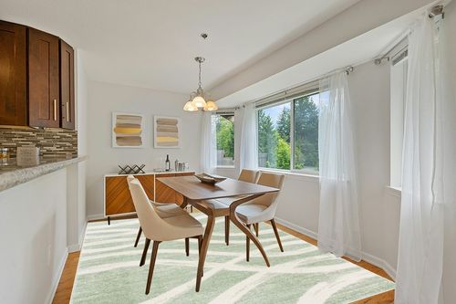SAFAVIEH Adirondack Collection Area Rug - 8' x 10', Sage & Cream, Modern Wave Distressed Design, Non-Shedding & Easy Care, Ideal for High Traffic Areas in Living Room, Bedroom (ADR125X) in Modern White Dining Room with Wooden Accents