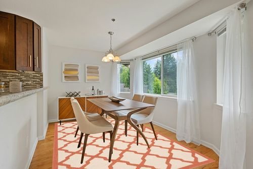 Safavieh Courtyard Beige & Terracotta 7'-10" x 7'-10" Square Indoor/Outdoor Rug in Modern White Dining Room with Wooden Accents