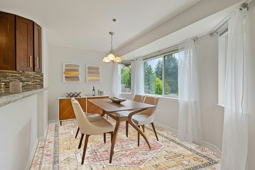 Loloi II Skye Collection SKY-04 GOLD / BLUSH, Traditional 9'-0" x 12'-0" Area Rug in Modern White Dining Room with Wooden Accents