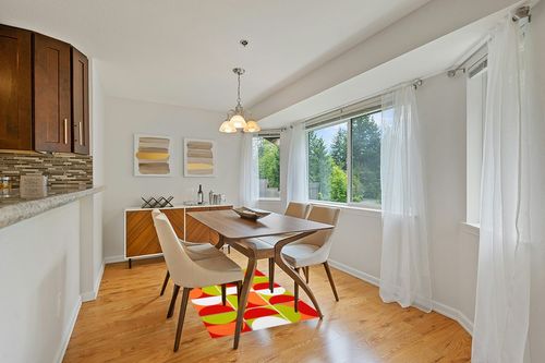 Mid Century Modern Abstract Orange Green Red Wool Area Rug 3x5 Vibrant Art Decor Minimalist Rug for Livingroom Bedroom Diningroom Boho Chic Floor Carpet in Modern White Dining Room with Wooden Accents