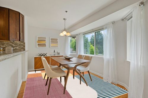 SAFAVIEH Orwell Collection Area Rug - 8' x 10', Rust & Yellow, Mid-Century Modern Abstract Design, Non-Shedding & Easy Care, Ideal for High Traffic Areas in Living Room, Bedroom (ORW368P) in Modern White Dining Room with Wooden Accents