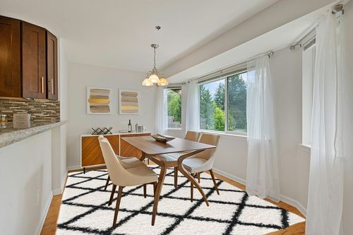 L'Baiet Halle White Black Geometric Diamond Pattern Modern Soft Shag Indoor 8' x 10' Area Rug in Modern White Dining Room with Wooden Accents