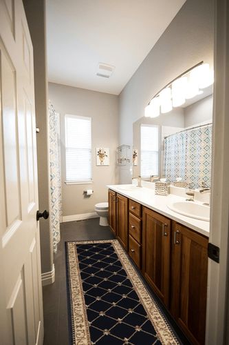 Orleans Traditional Border Black Runner Rug, 2' x 7' in Wooden and Grey Bathroom