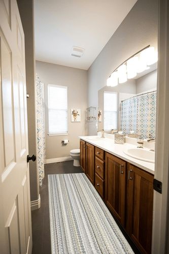 Garland Rug Carnival Stripe 2 Ft. x 8 Ft. Earth Tone Runner Rug in Wooden and Grey Bathroom