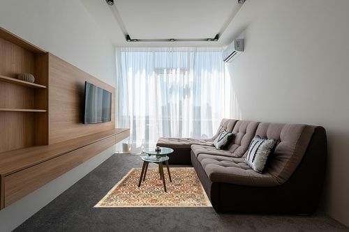 Antep Rugs Alfombras Non-Skid (Non-Slip) 5x7 Rubber Backing Floral Geometric Low Profile Pile Indoor Area Rugs (Beige Multi, 5' x 7') in Grey Living Room with Brown Couch