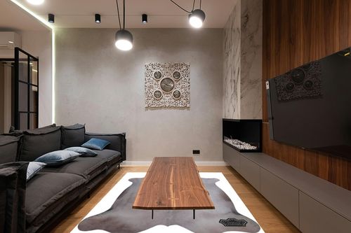 Appaloosa Cowhides Color Dyed Collection (Soft Gray) in Dark Wood Living Room with Black Couch