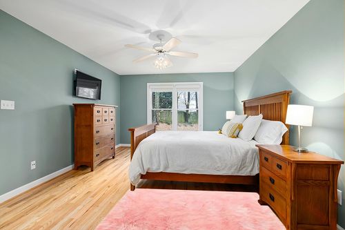 GHOUSE Light Pink 4 ft. x 6 ft. Silky Faux Fur Sheepskin Shag Fluffy Fuzzy Area Rug in Teal and Orange Wood Bedroom