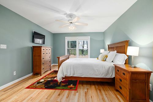 Milliken RJ McDonald Christmas Party Novelty Rug Rug Size: 5'4" x 7'8" in Teal and Orange Wood Bedroom