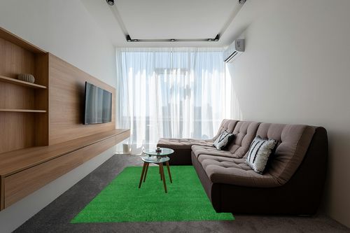 Garland Rug Artificial Grass 6 ft. x 9 ft. Large Indoor/Outdoor Area Rug Green in Grey Living Room with Brown Couch