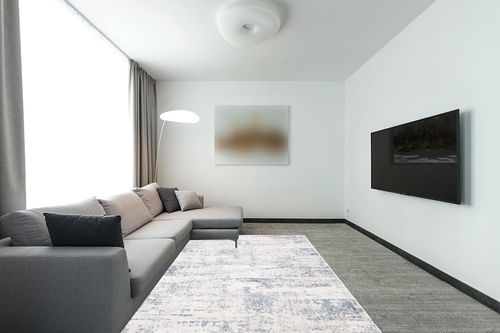 SAFAVIEH Amelia Collection Area Rug - 6' x 9', Ivory & Blue, Modern Abstract Design, Non-Shedding & Easy Care, Ideal for High Traffic Areas in Living Room, Bedroom (ALA700A) in Modern Living Room with Grey Couch