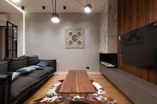 Sunshine Cowhides Genuine Brindle Tricolor Cowhide Rug - Luxurious Cow Rug for Bedroom, Living Room, and Home Decor Enthusiasts - Masterpiece of Style and Functionality - 6x6-7ft (180x210cm) in Dark Wood Living Room with Black Couch