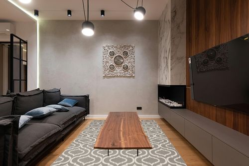 Nourison Jubilant Moroccan Trellis Grey Area Rug, (6' x 9') in Dark Wood Living Room with Black Couch
