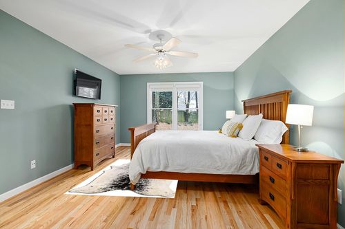 Cowhide Area Rug in Teal and Orange Wood Bedroom