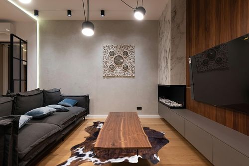 rodeo Classic Brown Brindle Cowhide Rug XXL 6x8 Ft in Dark Wood Living Room with Black Couch