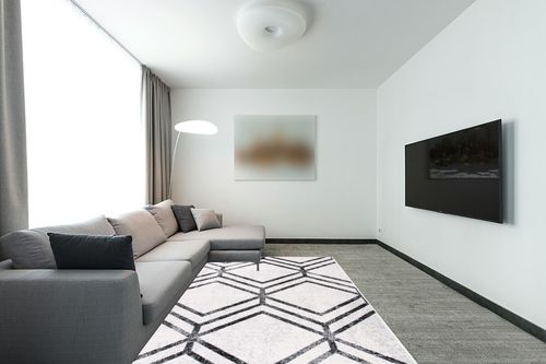 SAFAVIEH Adirondack Collection Area Rug - 6' x 9', Ivory & Charcoal, Modern Geometric Distressed Design, Non-Shedding & Easy Care, Ideal for High Traffic Areas in Living Room, Bedroom (ADR253B) in Modern Living Room with Grey Couch