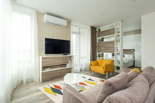 ARTSHOWING Europen Modern Mid Century Large Area Rug 5' x 7', Durable Indoor Outdoor Rugs with Non-Slip Backing for Bedroom Living Room Nursery Kids Home Decor, Orange Yellow Green Prismatic in Light Modern Living Room with TV