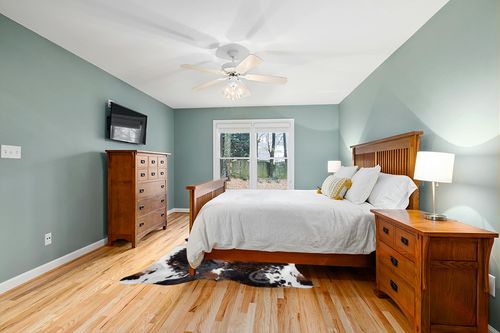 Sunshine Cowhides Genuine Brindle Dark Tricolor Cowhide Rug - Luxurious Cow Rug for Bedroom, Living Room, and Home Decor Enthusiasts - Masterpiece of Style and Functionality - 6x6-7ft (180x210cm) in Teal and Orange Wood Bedroom