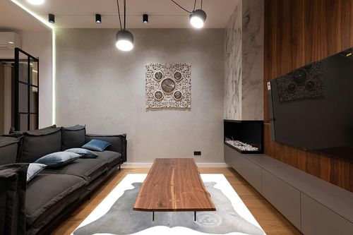 Sunshine Cowhides Genuine Grey Cowhide Rug - Luxurious Cow Rug for Bedroom, Living Room, and Home Decor Enthusiasts - Masterpiece of Style and Functionality - 6x6-7ft (180x210cm) in Dark Wood Living Room with Black Couch