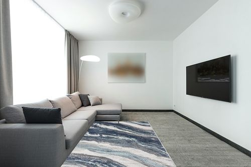 LUXE WEAVERS Lagos Collection 7983 Blue 5x7 Art Deco Area Rug in Modern Living Room with Grey Couch