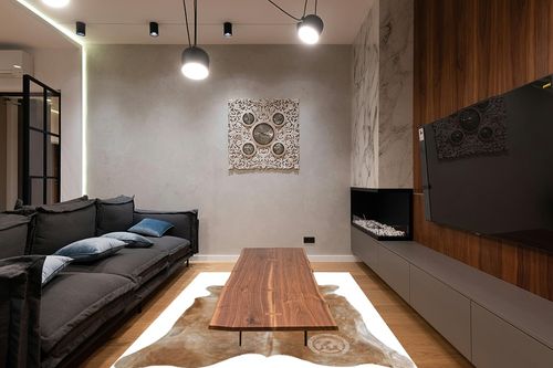 Genuine Palomino Beige Cowhide Rug 6 x 7-8 ft. 180 x 240 cm in Dark Wood Living Room with Black Couch