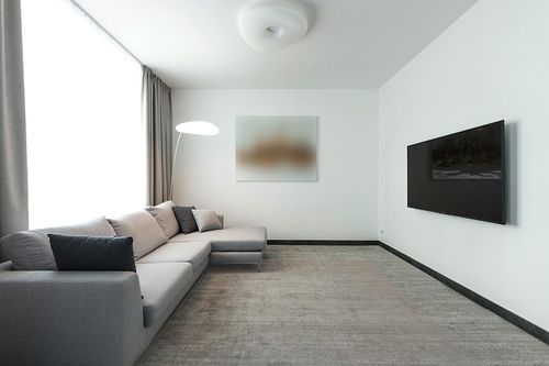 Linon Haven Lux Soft Faux Rabbit White Solid Colored 8' X 10' Area Rug in Modern Living Room with Grey Couch
