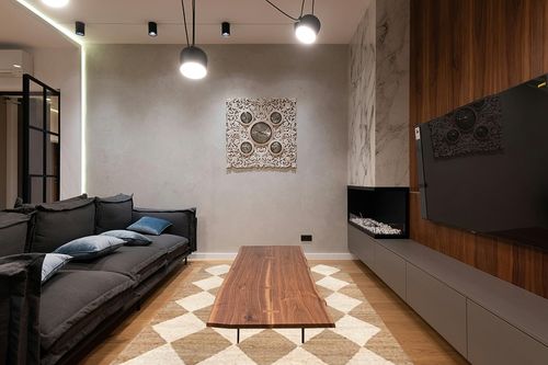 Rugs USA x Arvin Olano Louie Diamond Checkerboard Jute Area Rug, 6x9, Natural in Dark Wood Living Room with Black Couch