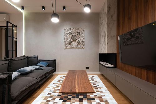 Cowhide Brown Patchwork Home Decorative Area Rug & Carpet Hand Made Cow Leather Hair (6'x9') in Dark Wood Living Room with Black Couch