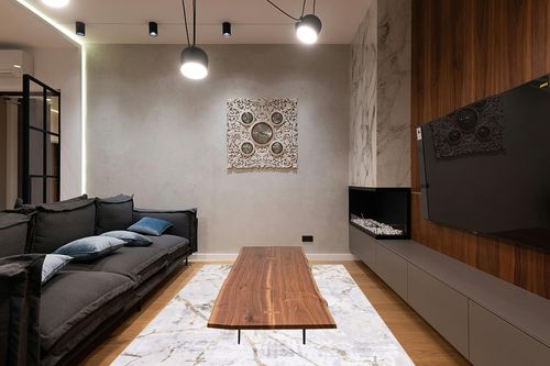 SAFAVIEH Amelia Collection Area Rug - 6' x 9', Grey & Gold, Modern Abstract Design, Non-Shedding & Easy Care, Ideal for High Traffic Areas in Living Room, Bedroom (ALA293G) in Dark Wood Living Room with Black Couch