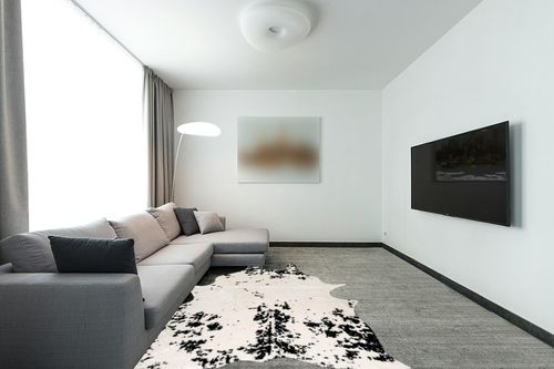 nuLOOM Marcia Machine Washable Faux Cowhide Area Rug, 5' 9" x 7' 7", Black in Modern Living Room with Grey Couch