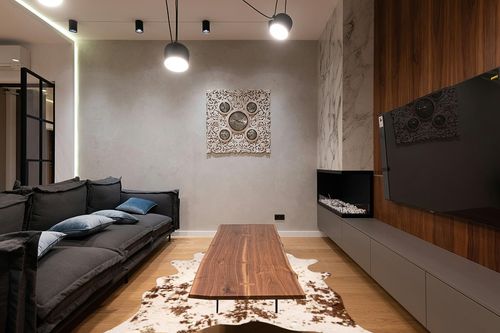 nuLOOM Iraida Contemporary Faux Cowhide Area Rug, 5' 9" x 7' 7", Brown in Dark Wood Living Room with Black Couch